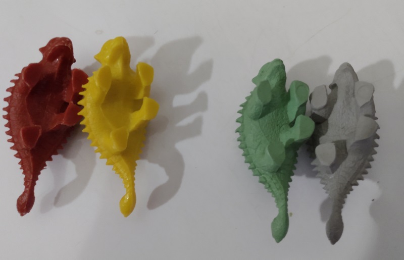 FOUR COLORFUL ANKYLOSAURUS ON THEIR BACK SHOWING BOTTOM OF FEET