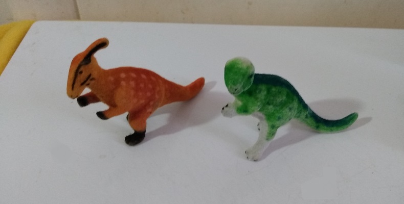 TWO FLOCKED DINOSAURS