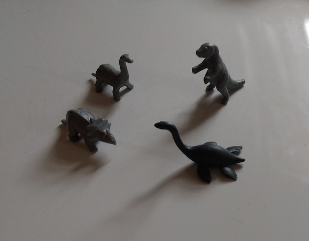 FOUR KELLOGGS DINOSAUR FIGURES