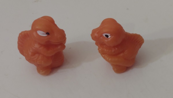 TWO ORANGE HOLLOW VENDING MACHINE DINOSAURS