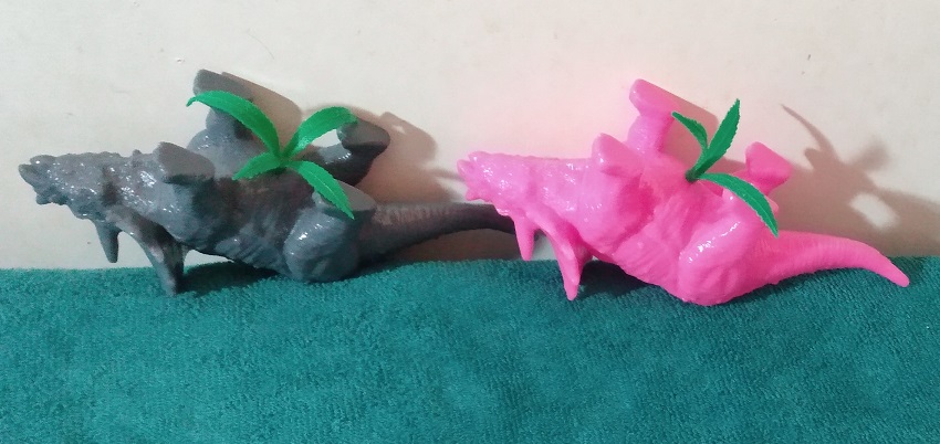 TRICERATOPS PLANTERS WITH PLASTIC PLANTS INSERTED WRONG